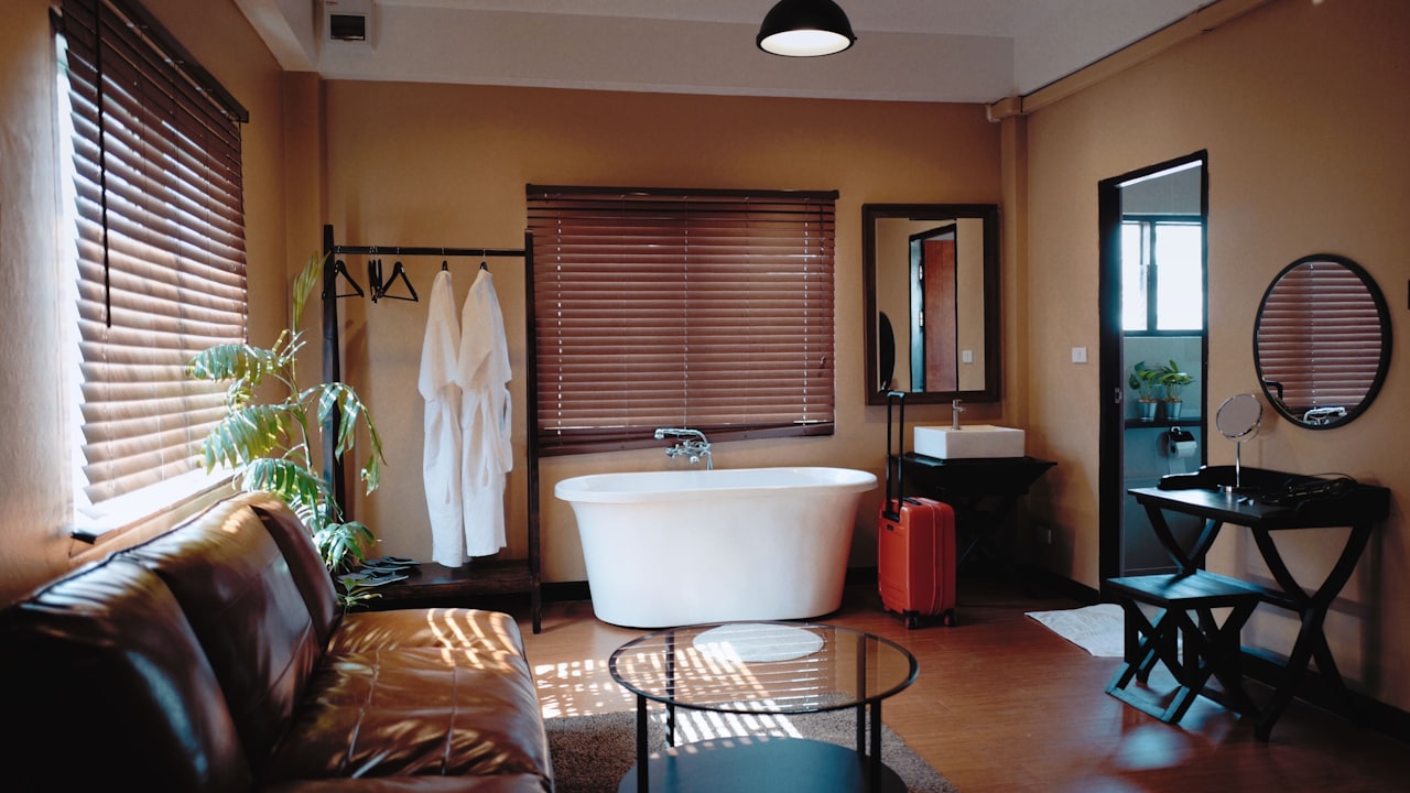 A furnished short-term-rental suite with a freestanding tub and lounge seating